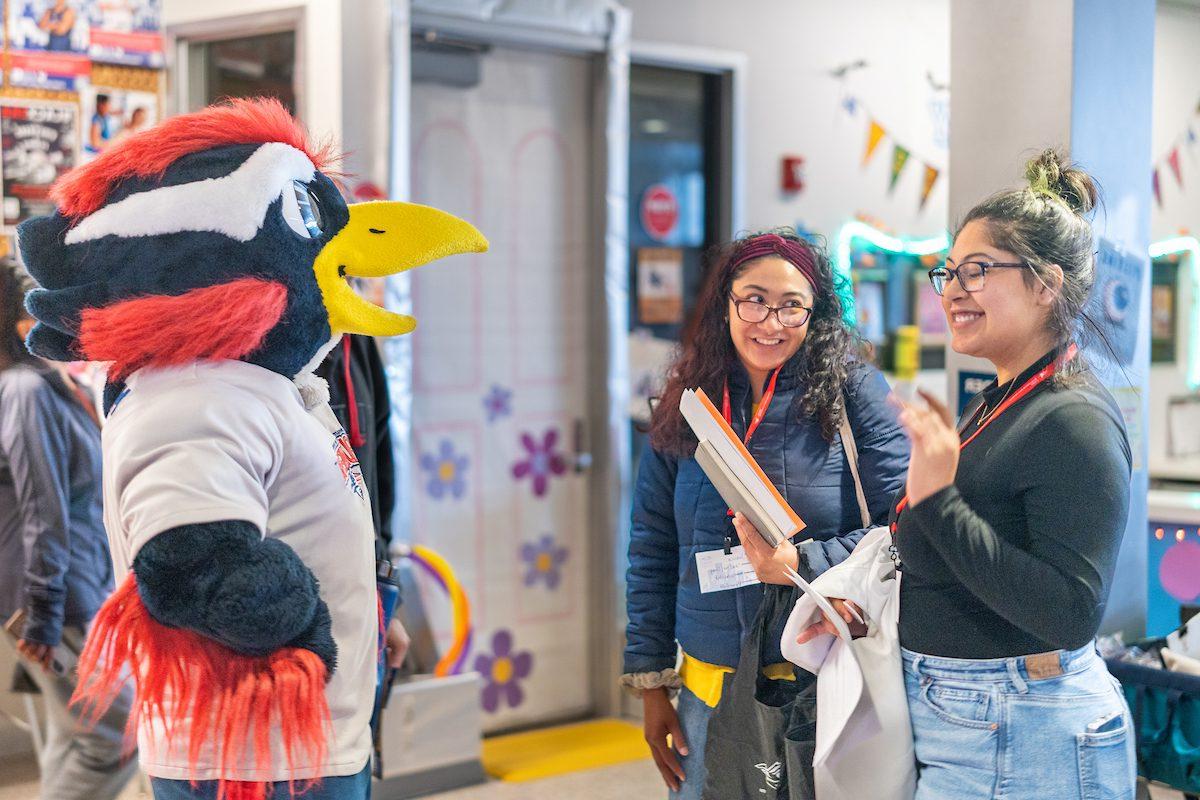 Rowdy talking with two students